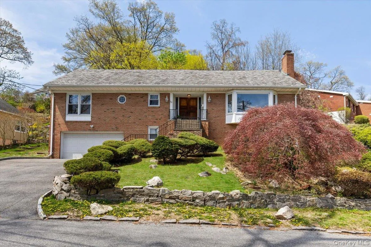 Ranch-style house with asphalt driveway, brick siding, a chimney, and a garage Ranch-style house with asphalt driveway, brick siding, a chimney, and a garage