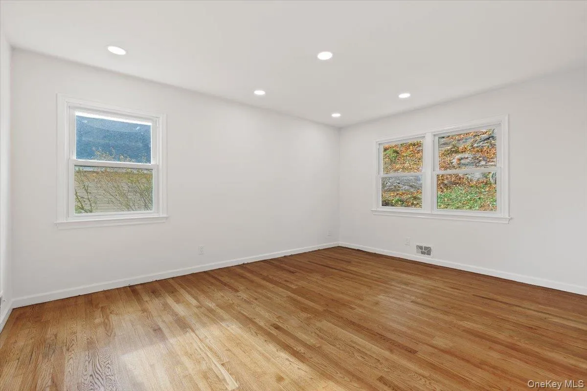 Spare room featuring healthy amount of natural light, recessed lighting, and light wood-style floors Spare room featuring healthy amount of natural light, recessed lighting, and light wood-style floors