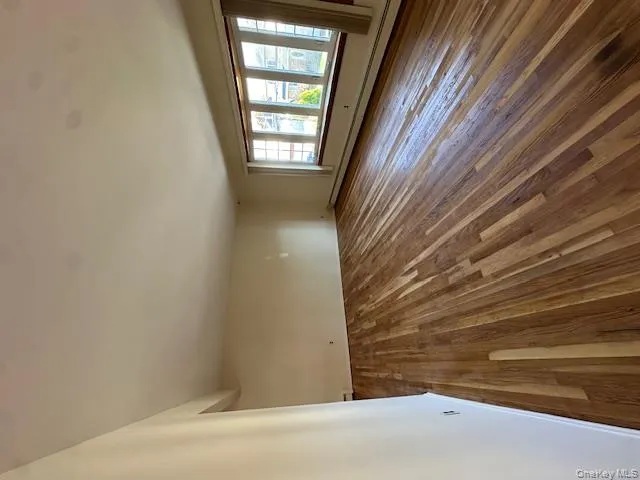 Spare room featuring baseboard heating and wood-type flooring Spare room featuring baseboard heating and wood-type flooring