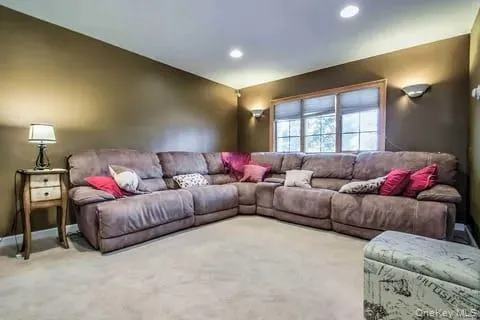 Carpeted living room featuring recessed lighting and baseboards Carpeted living room featuring recessed lighting and baseboards