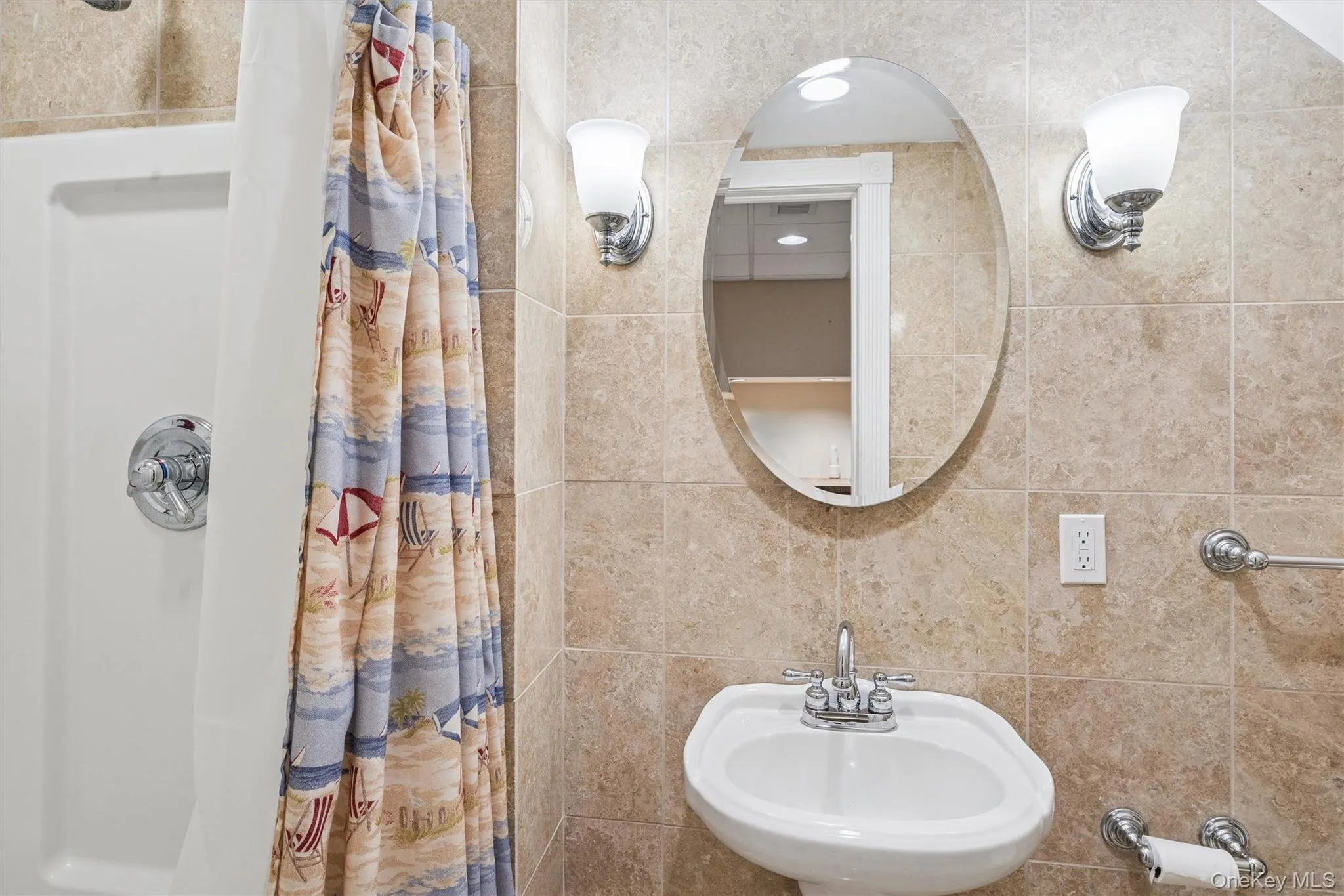 Full bath featuring a sink and a shower stall Full bath featuring a sink and a shower stall