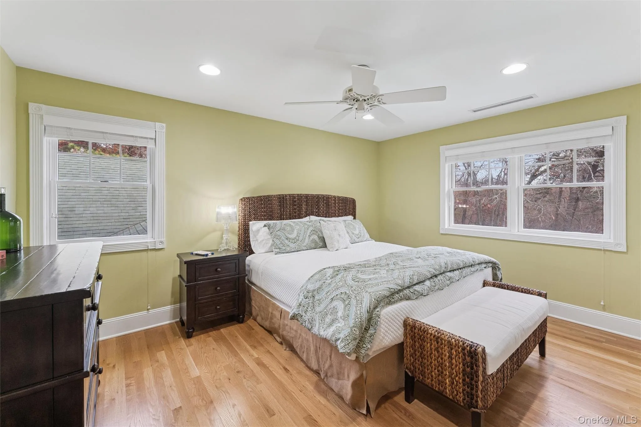 Bedroom featuring light wood-type flooring, multiple windows, ceiling fan, and recessed lighting Bedroom featuring light wood-type flooring, multiple windows, ceiling fan, and recessed lighting