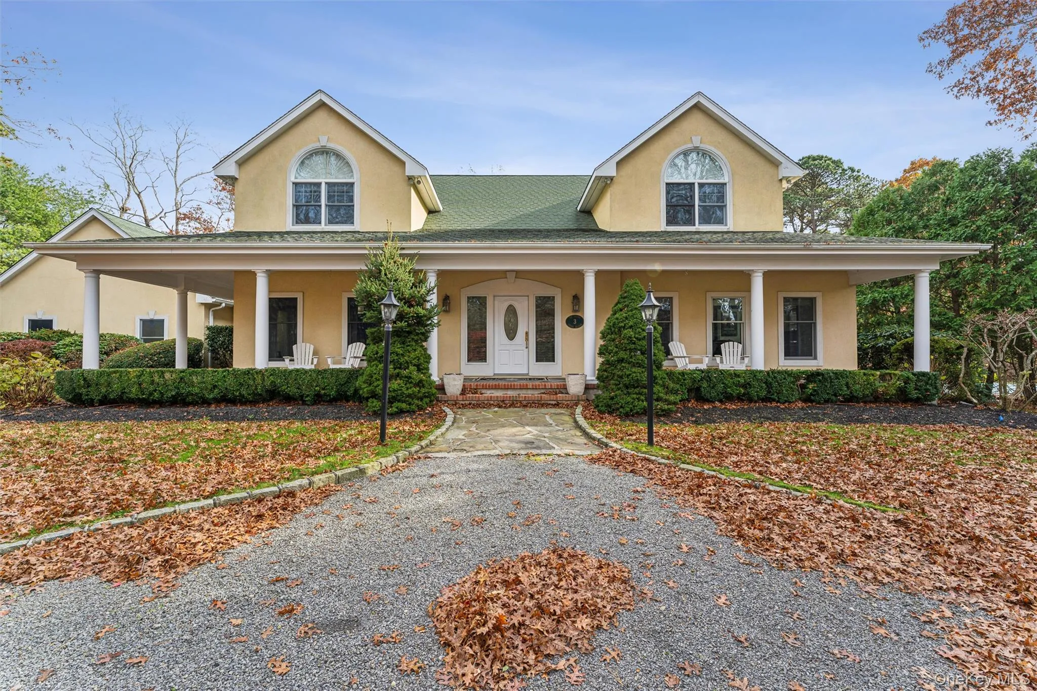 Farmhouse inspired home with stucco siding and a porch Farmhouse inspired home with stucco siding and a porch