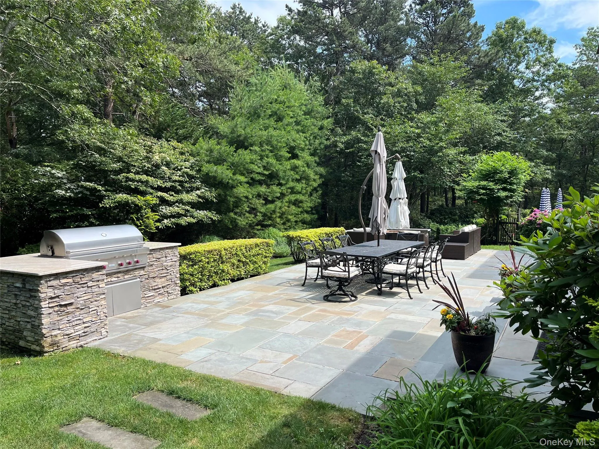 View of patio / terrace with an outdoor kitchen and outdoor dining area View of patio / terrace with an outdoor kitchen and outdoor dining area