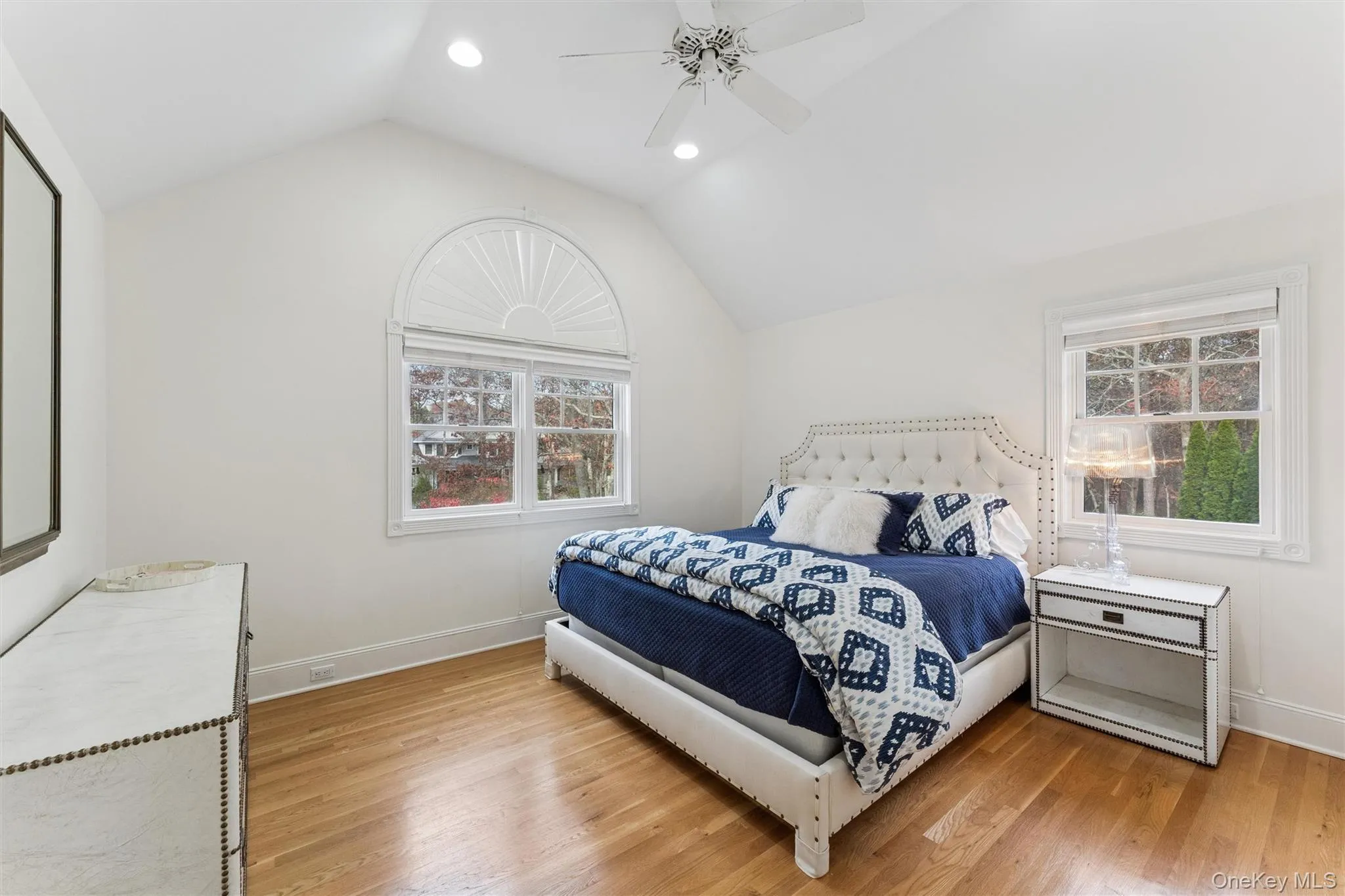 Bedroom with light wood finished floors, vaulted ceiling, recessed lighting, and ceiling fan Bedroom with light wood finished floors, vaulted ceiling, recessed lighting, and ceiling fan