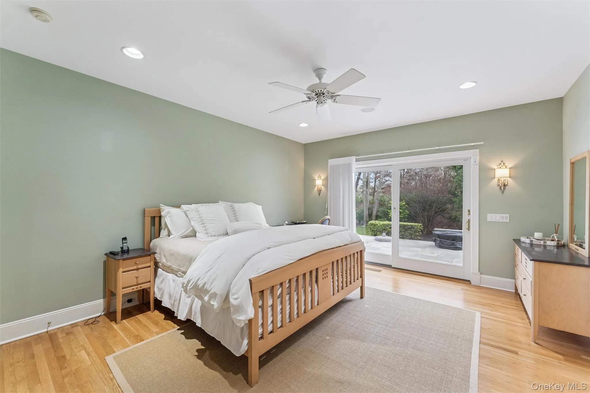 Bedroom featuring access to outside, light wood finished floors, a ceiling fan, and recessed lighting Bedroom featuring access to outside, light wood finished floors, a ceiling fan, and recessed lighting