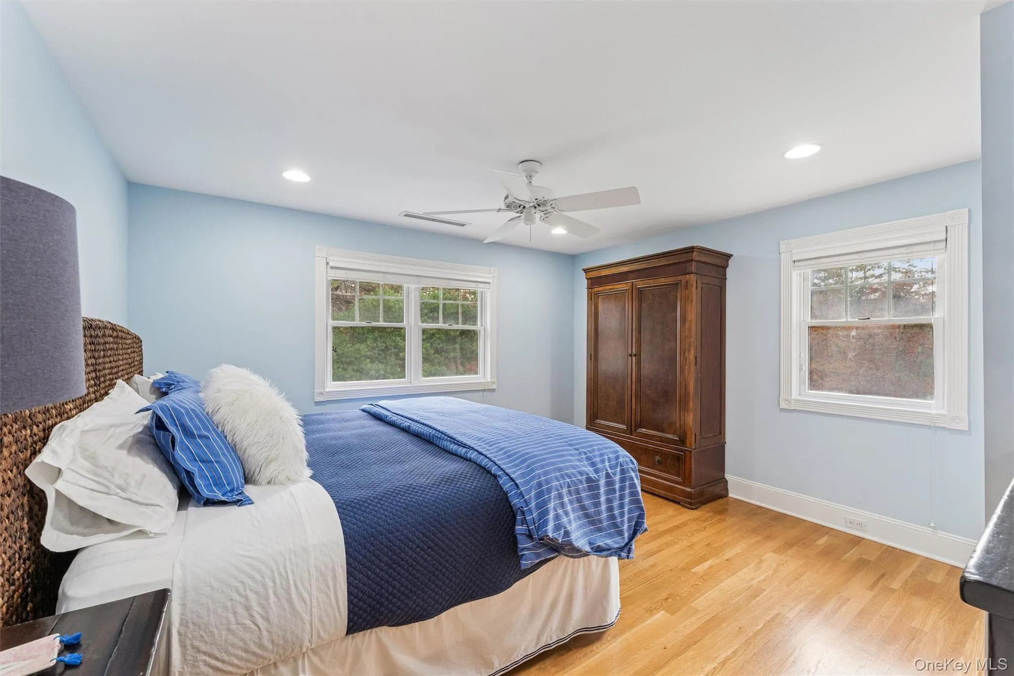 Bedroom featuring light wood-style floors, a ceiling fan, and recessed lighting Bedroom featuring light wood-style floors, a ceiling fan, and recessed lighting