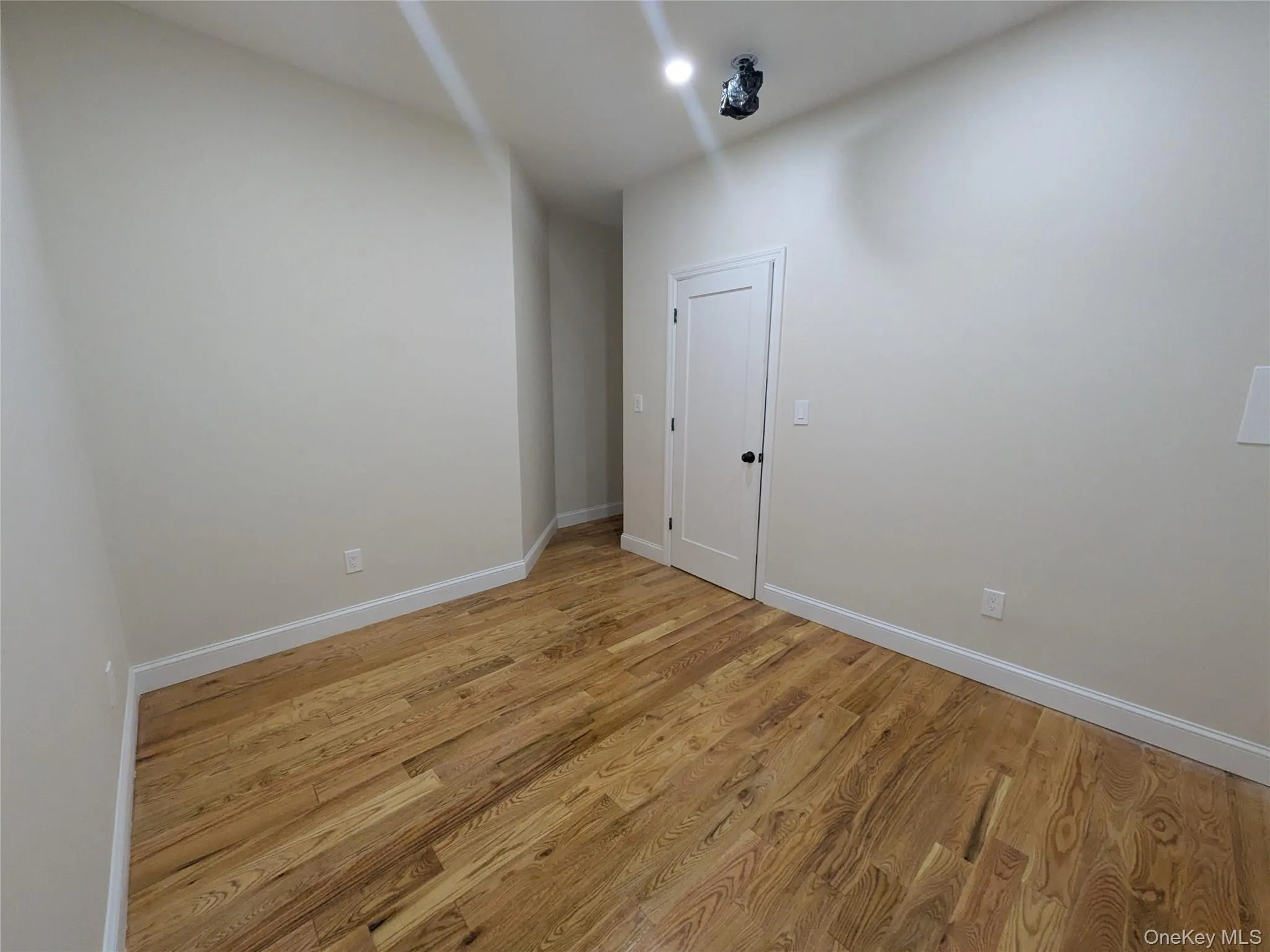 Empty room featuring baseboards and light wood-style flooring Empty room featuring baseboards and light wood-style flooring