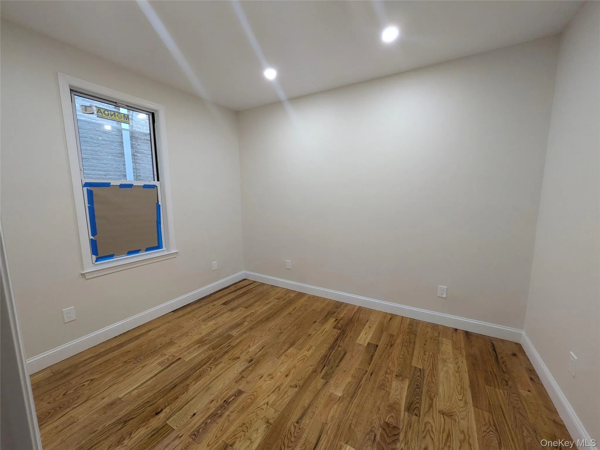 Spare room with light wood-type flooring and recessed lighting Spare room with light wood-type flooring and recessed lighting