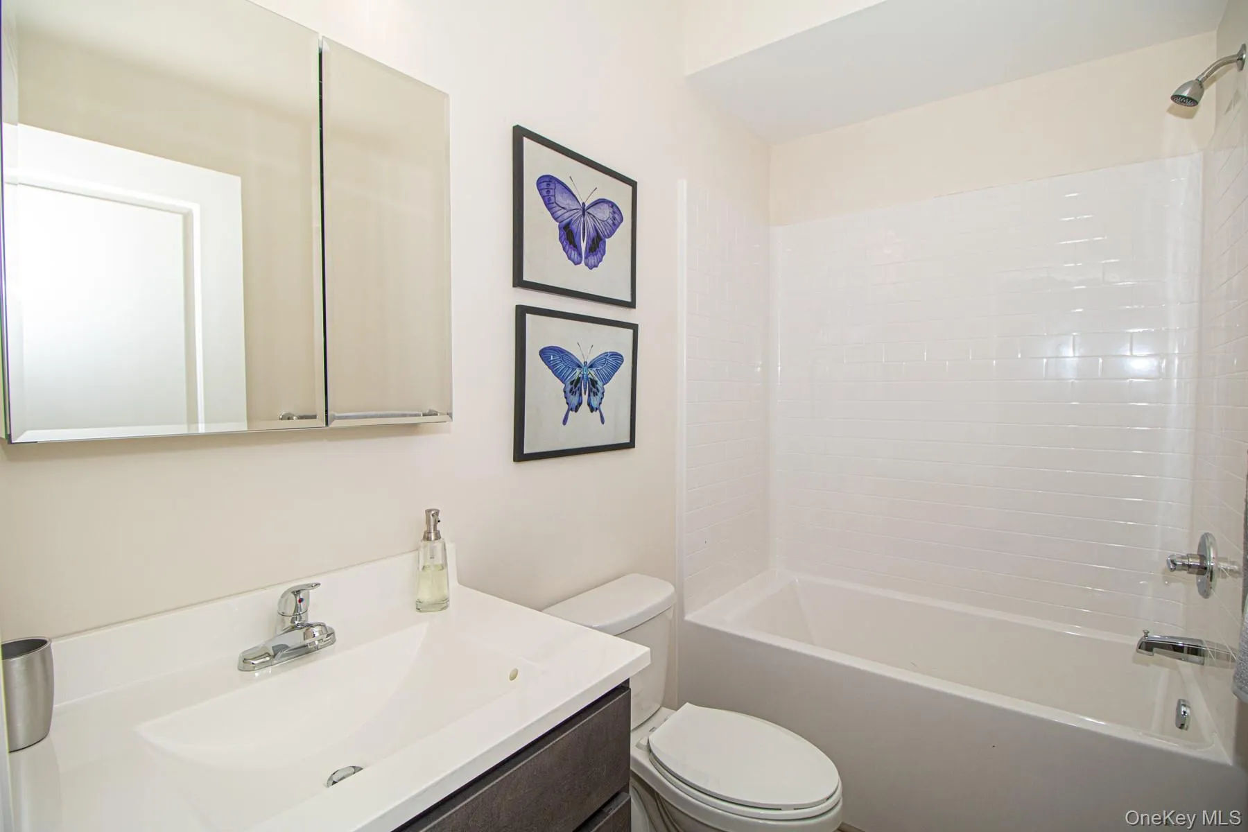 Bathroom featuring shower / bath combination and vanity Bathroom featuring shower / bath combination and vanity
