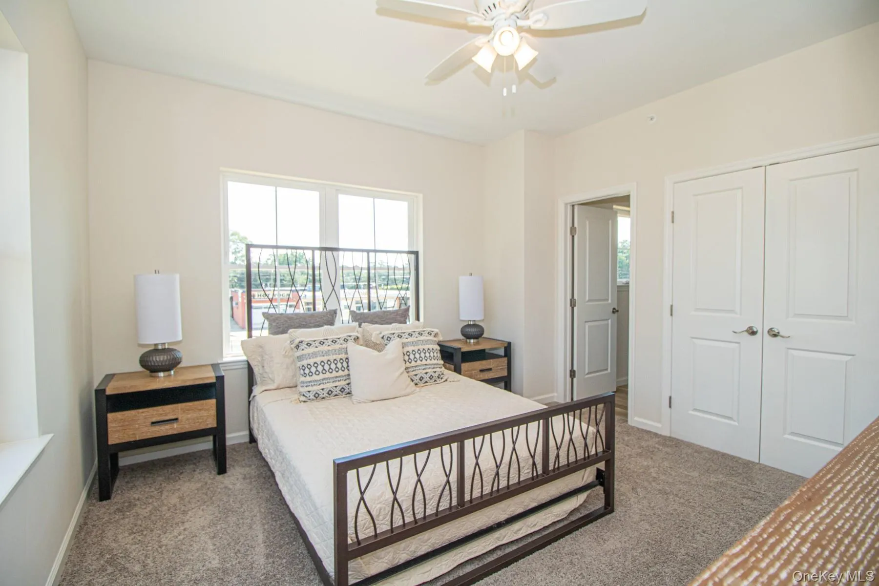 Bedroom with dark colored carpet, ceiling fan, and a closet Bedroom with dark colored carpet, ceiling fan, and a closet