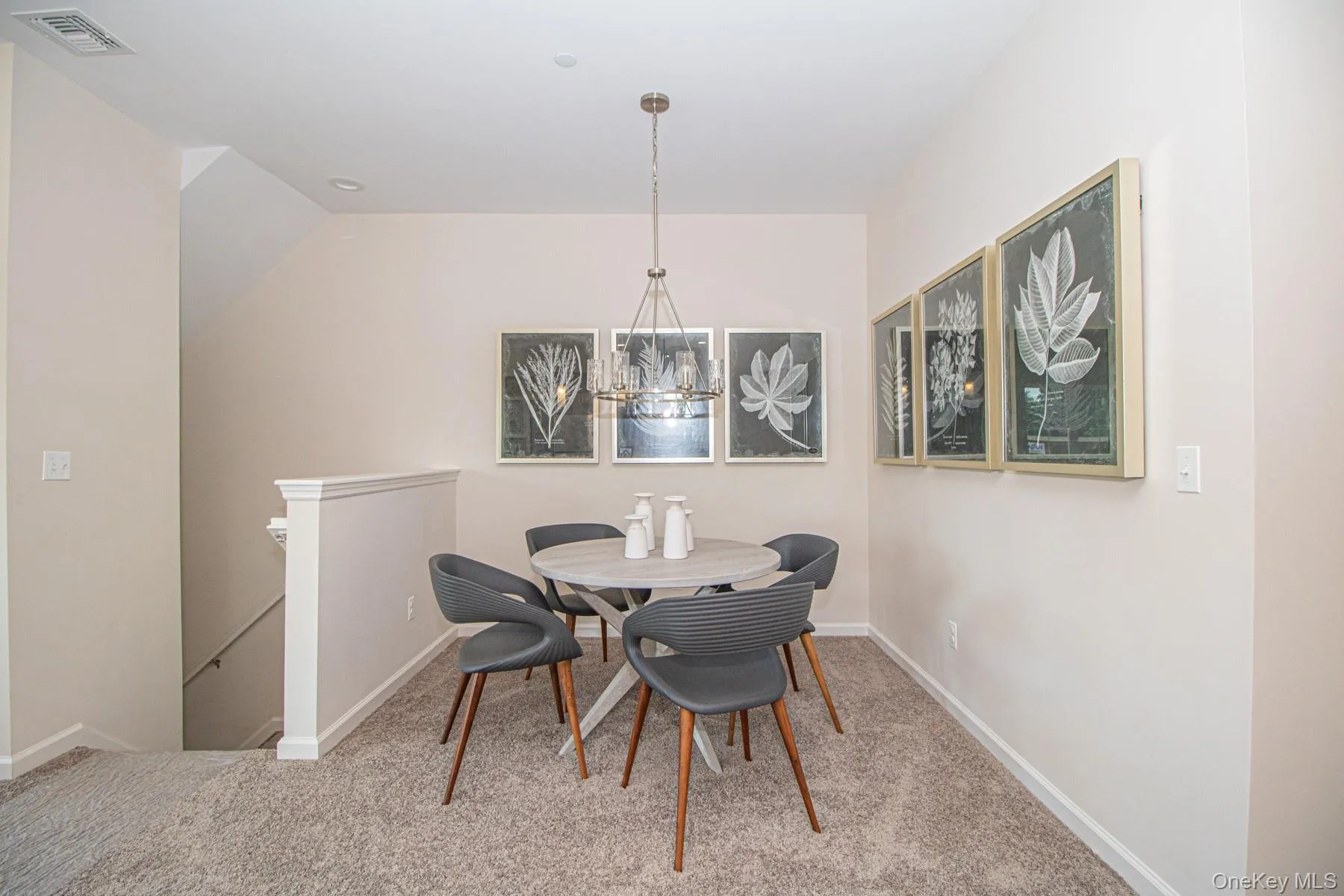 Dining space featuring light colored carpet and a chandelier Dining space featuring light colored carpet and a chandelier