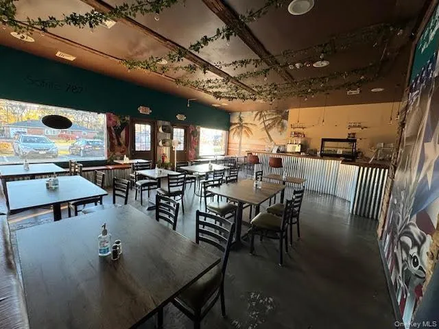 Dining room featuring finished concrete floors Dining room featuring finished concrete floors