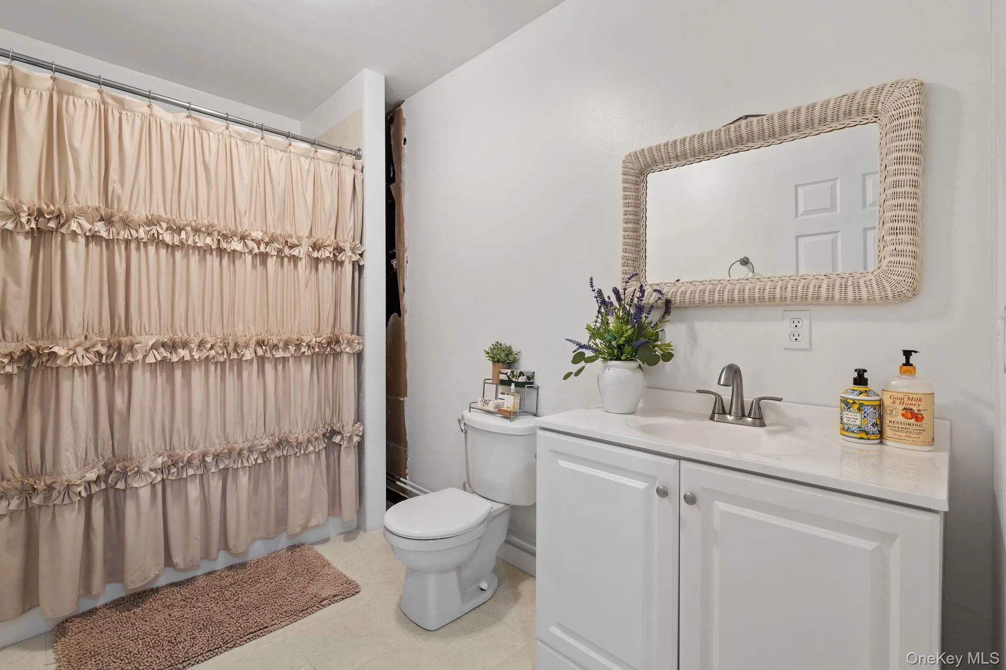 Bathroom featuring vanity and curtained shower Bathroom featuring vanity and curtained shower