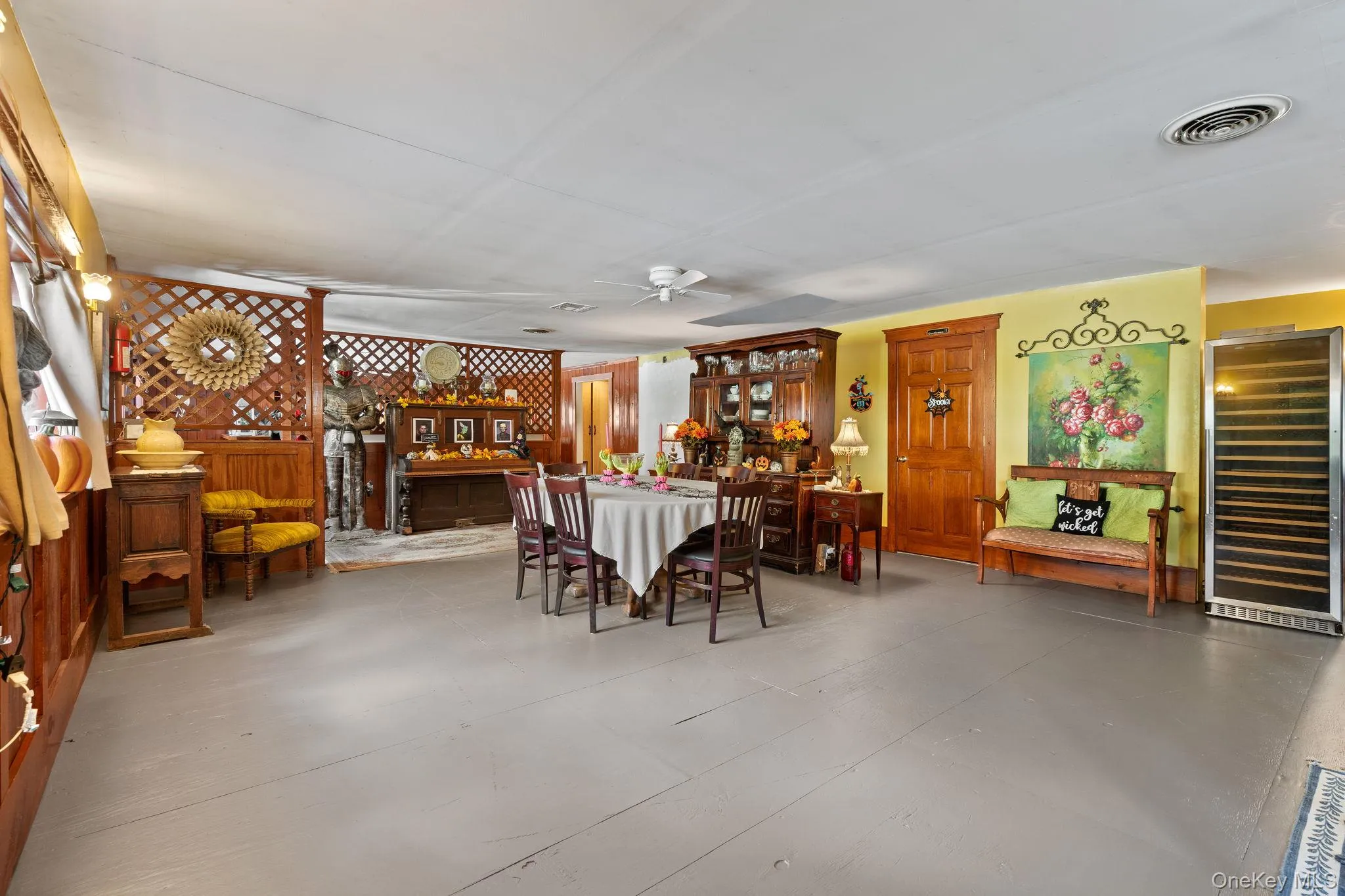 Dining space featuring beverage cooler and concrete flooring Dining space featuring beverage cooler and concrete flooring