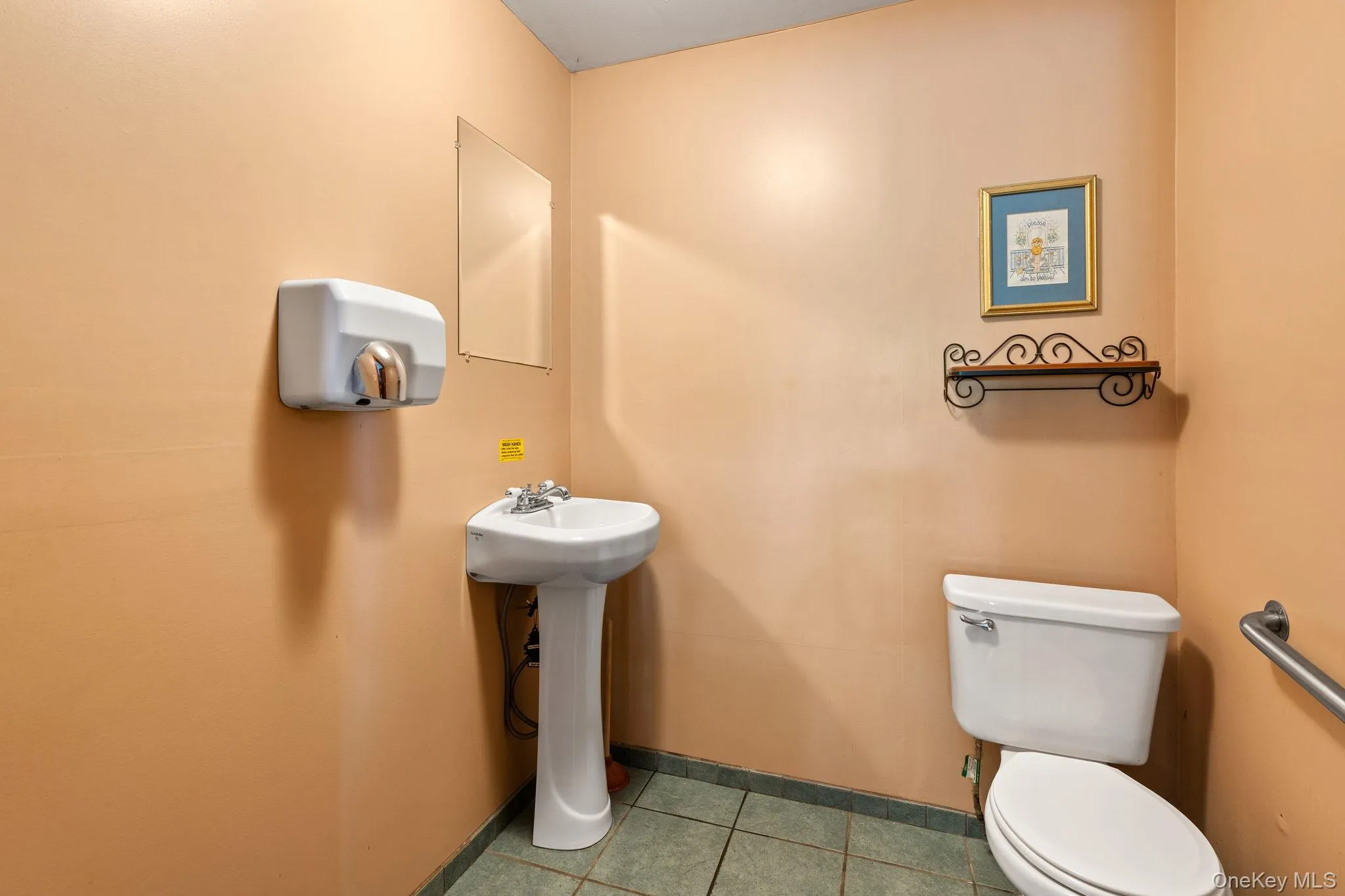 Half bath featuring toilet and light tile patterned flooring Half bath featuring toilet and light tile patterned flooring