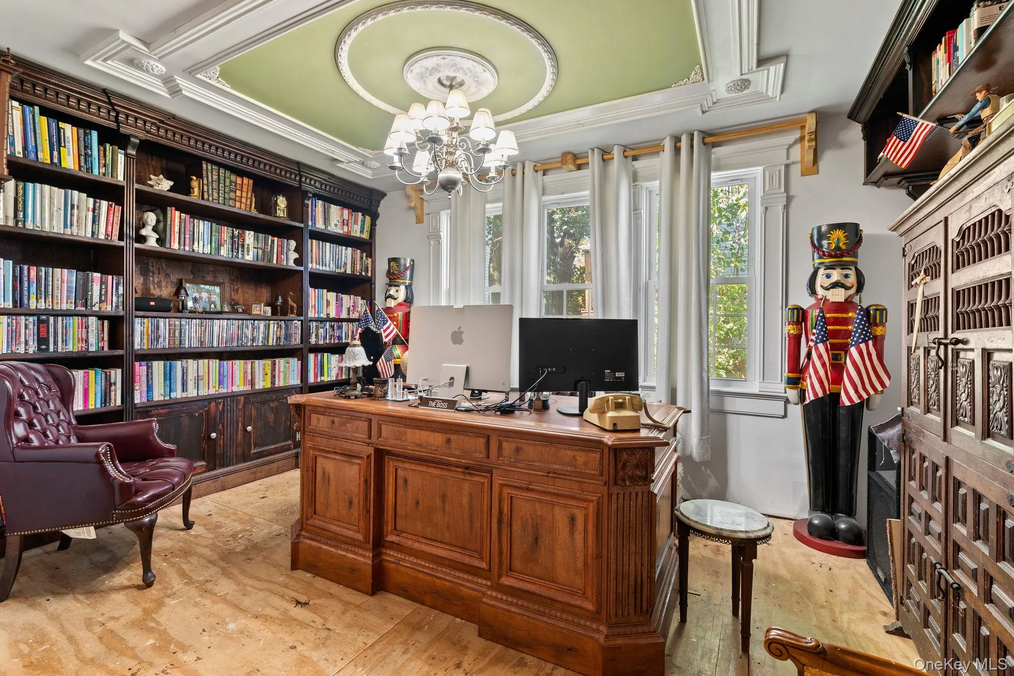 Office space with a chandelier and a raised ceiling Office space with a chandelier and a raised ceiling