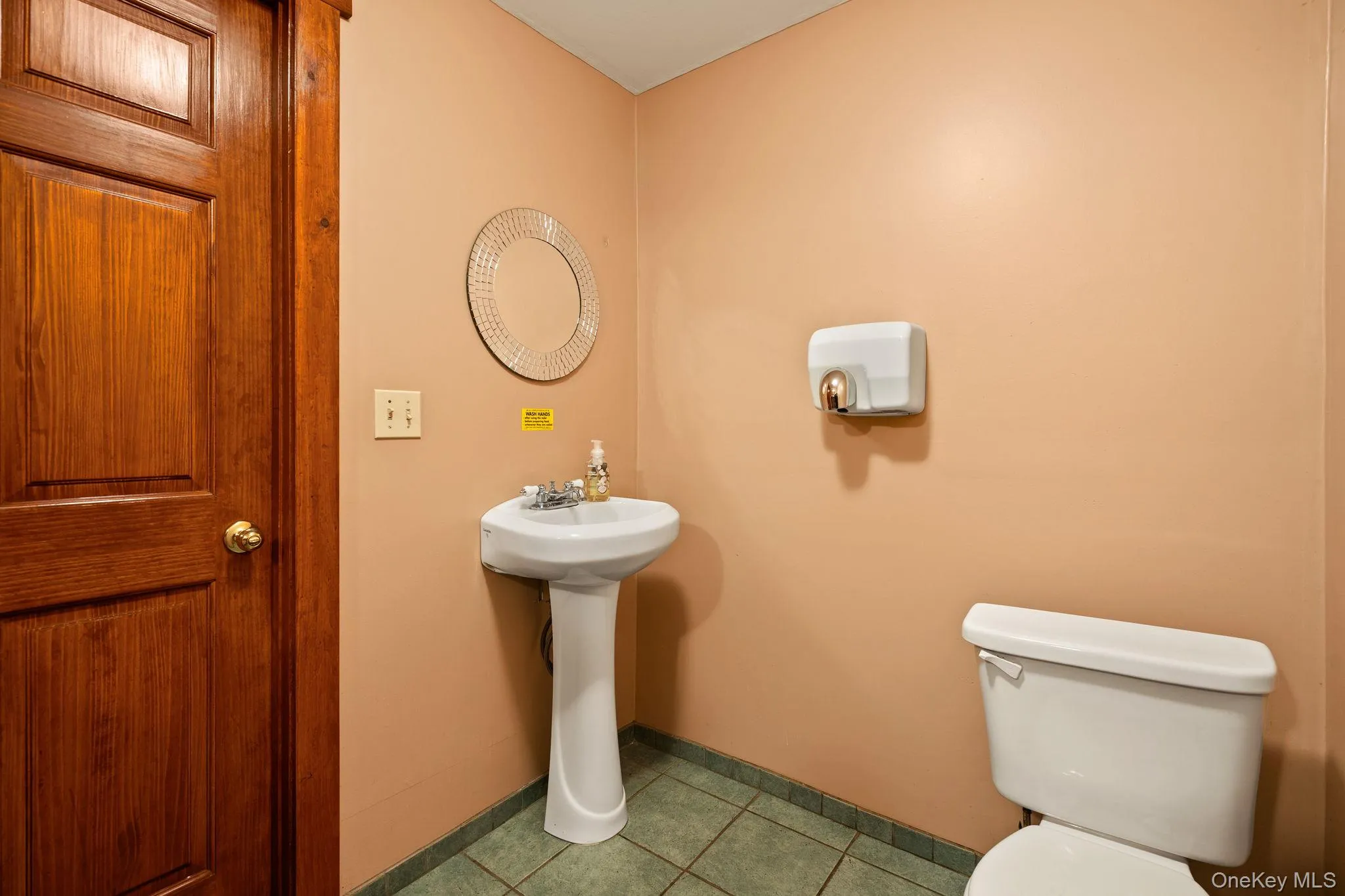 Half bathroom featuring light tile patterned floors and toilet Half bathroom featuring light tile patterned floors and toilet