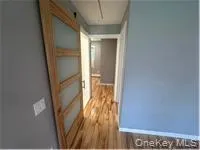 Hall with attic access and dark wood finished floors Hall with attic access and dark wood finished floors