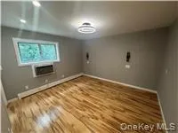 Empty room with wood finished floors and baseboards Empty room with wood finished floors and baseboards