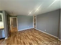 Empty room with dark wood-style floors and baseboards Empty room with dark wood-style floors and baseboards