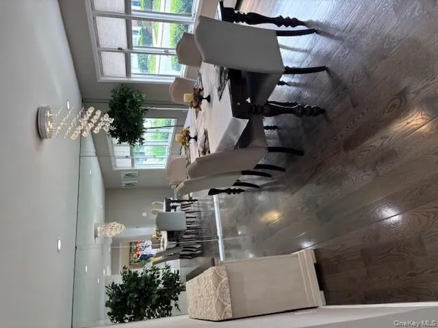 Dining area with dark wood-style flooring and a chandelier Dining area with dark wood-style flooring and a chandelier