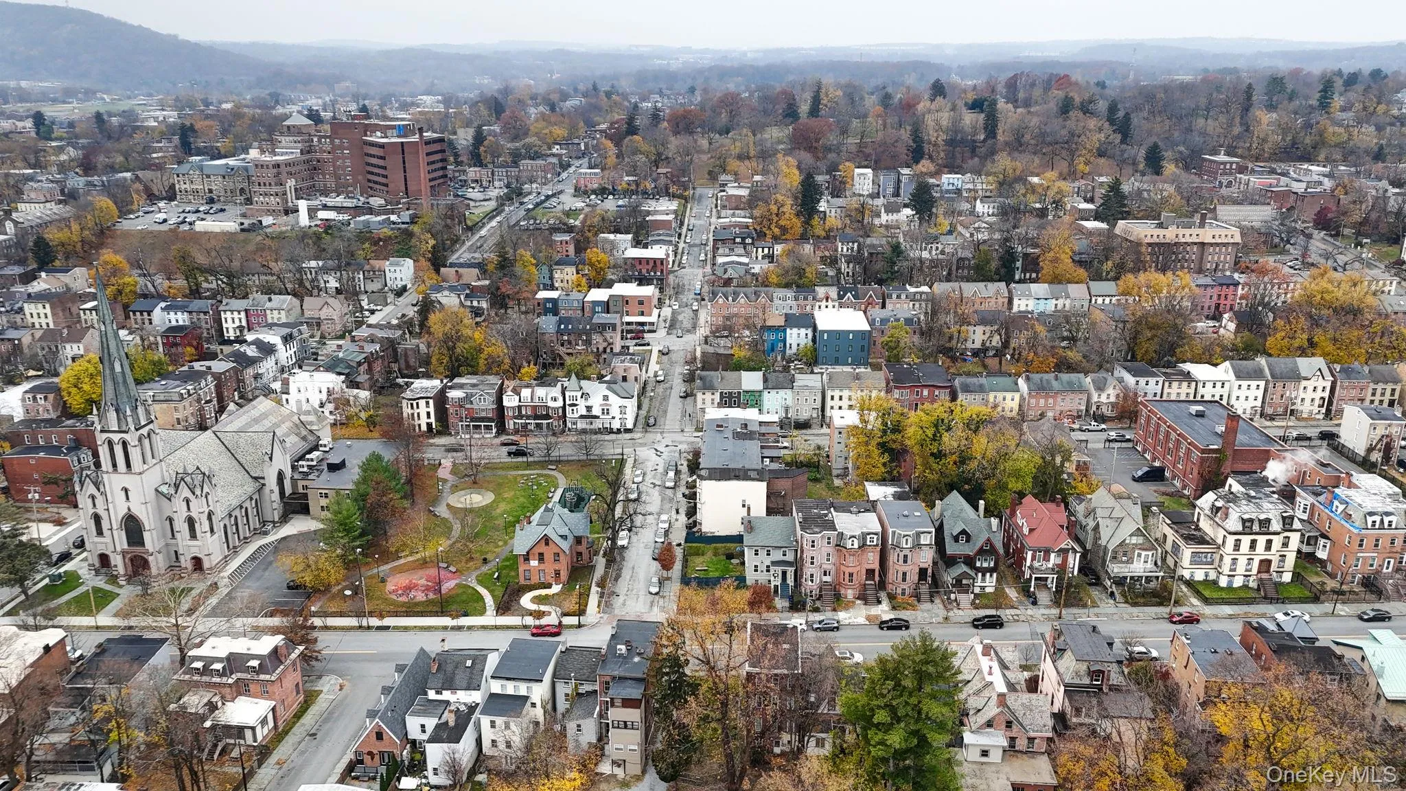 Aerial view of property's location featuring nearby urban area and a mountain backdrop Aerial view of property's location featuring nearby urban area and a mountain backdrop