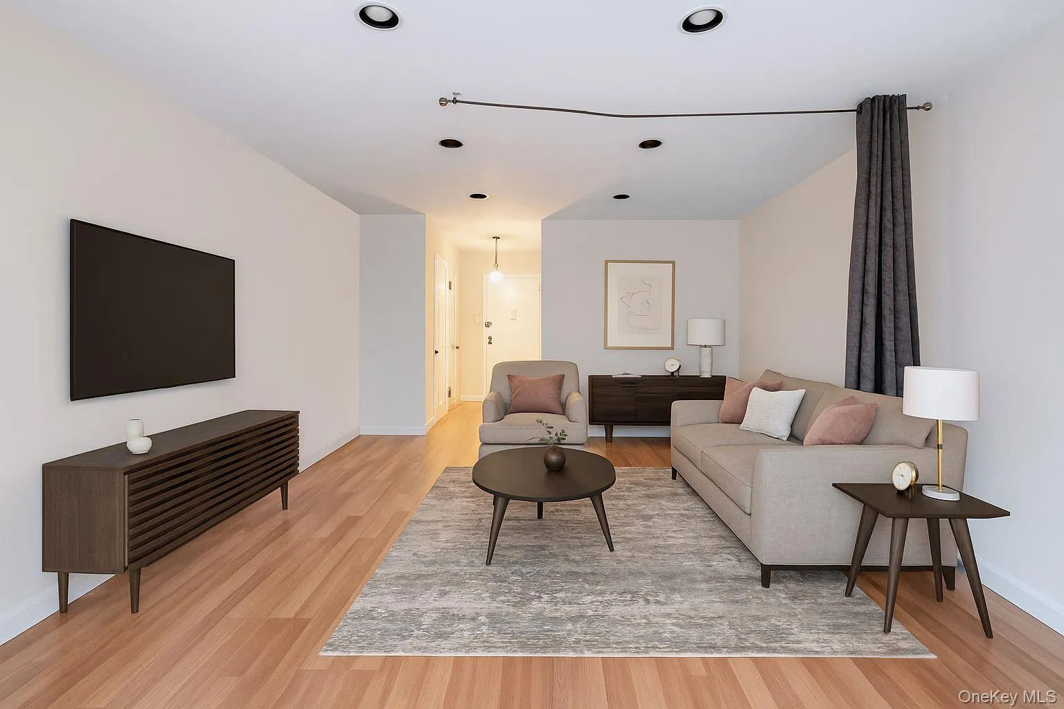 Virtually Staged Living space with light wood finished floors and baseboards Virtually Staged Living space with light wood finished floors and baseboards