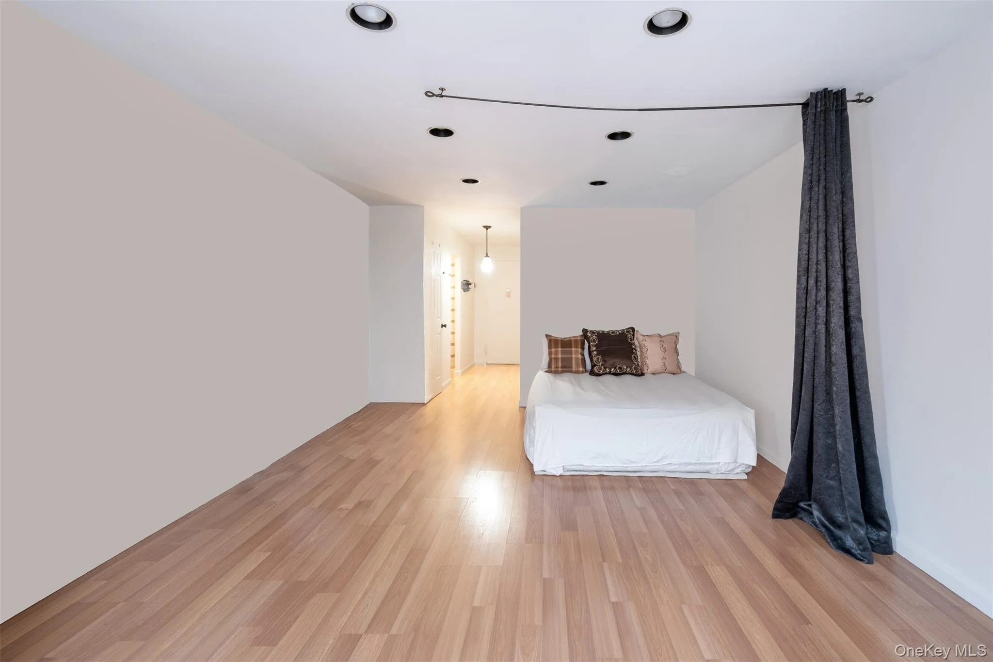 Bedroom with light wood-style floors and recessed lighting Bedroom with light wood-style floors and recessed lighting