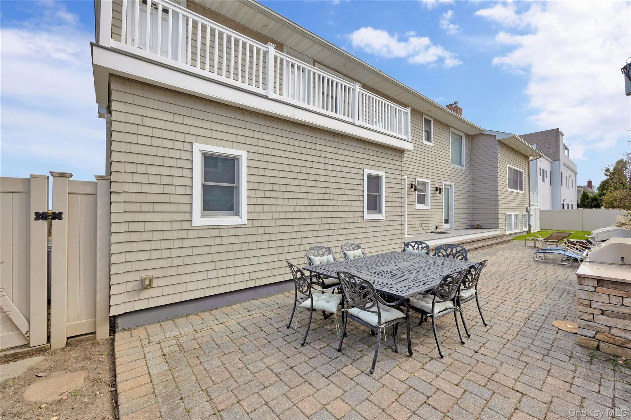 Patio / terrace featuring a patio area, outdoor dining space, and a gate Patio / terrace featuring a patio area, outdoor dining space, and a gate