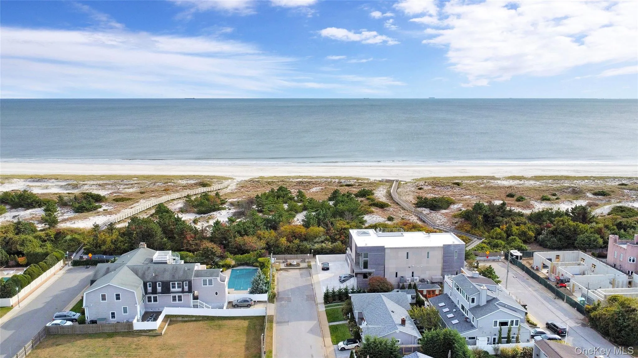 Aerial view of residential area featuring extended coastline Aerial view of residential area featuring extended coastline