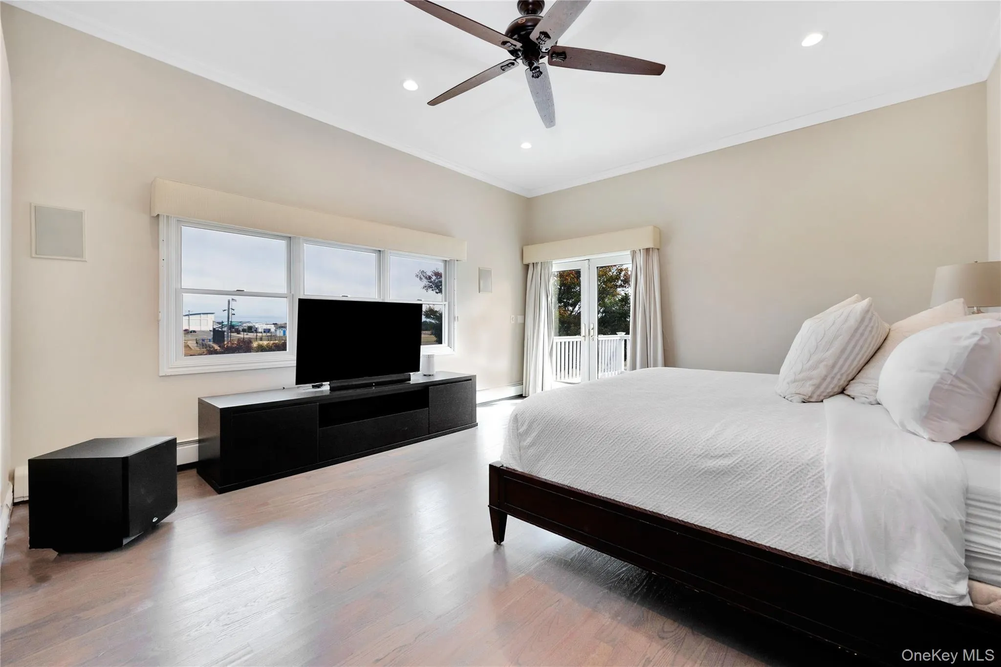 Bedroom featuring ornamental molding, access to exterior, recessed lighting, wood finished floors, and a ceiling fan Bedroom featuring ornamental molding, access to exterior, recessed lighting, wood finished floors, and a ceiling fan