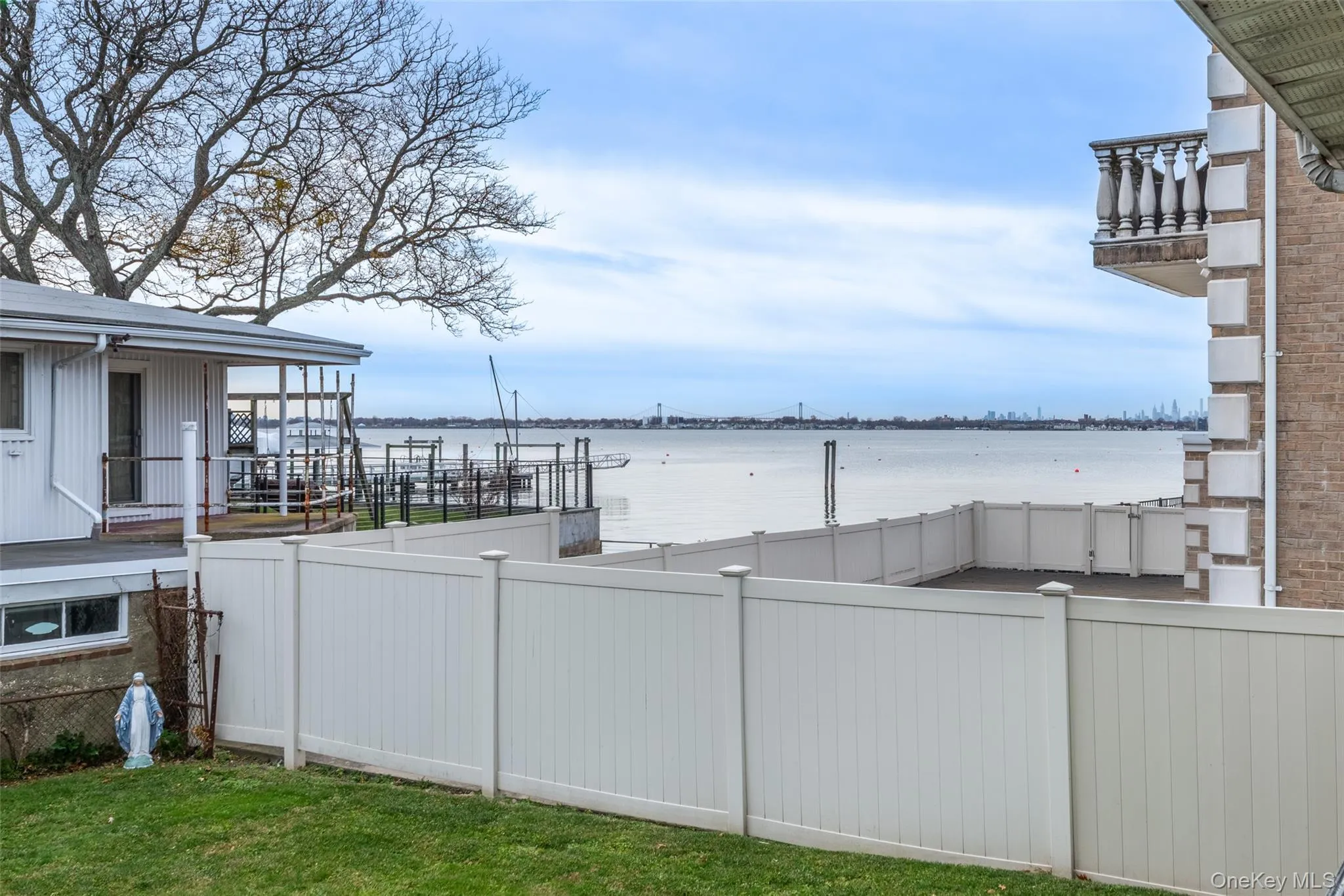 View of yard with a balcony and a water view View of yard with a balcony and a water view