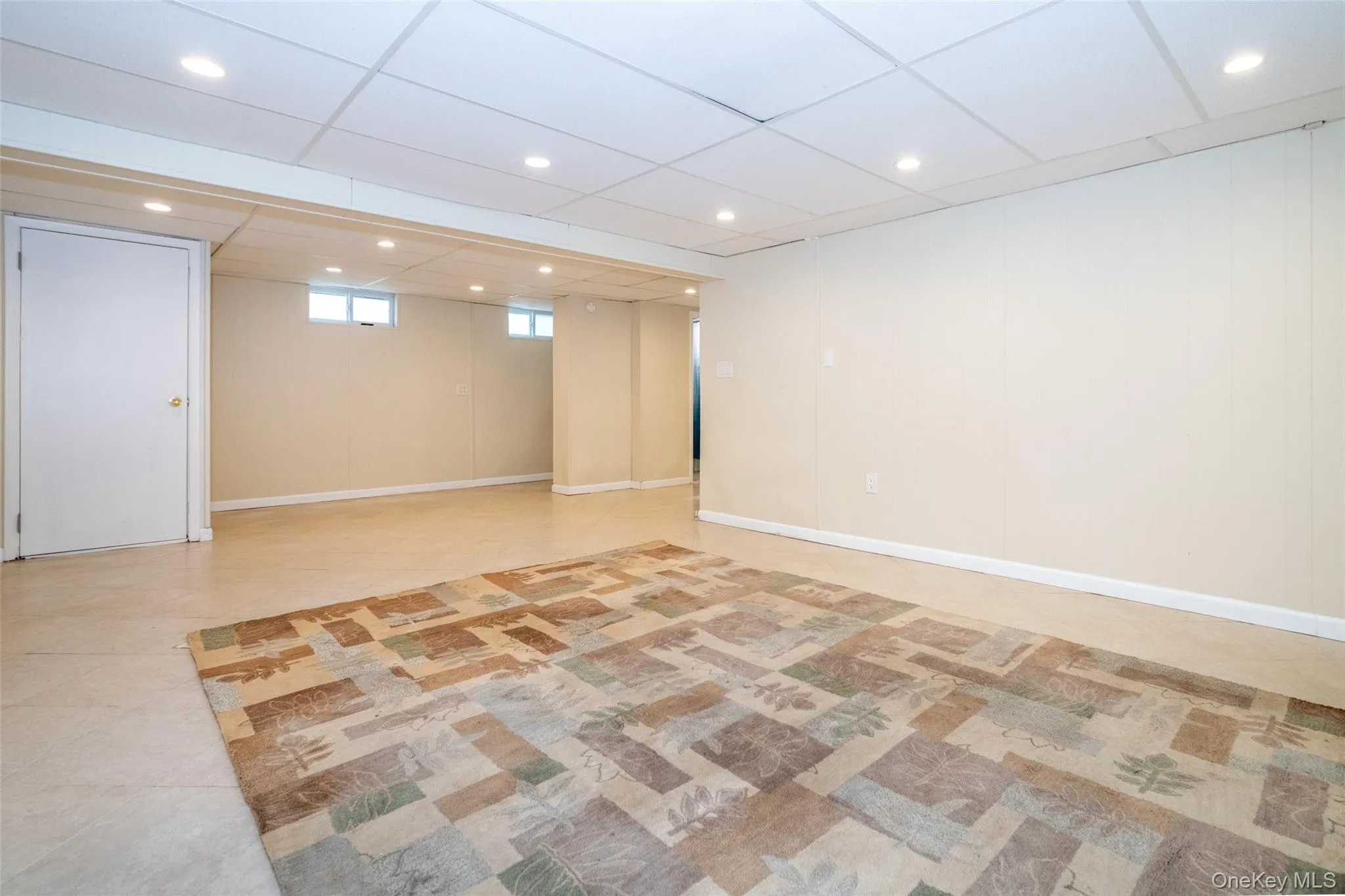 Below grade area with a paneled ceiling and recessed lighting Below grade area with a paneled ceiling and recessed lighting