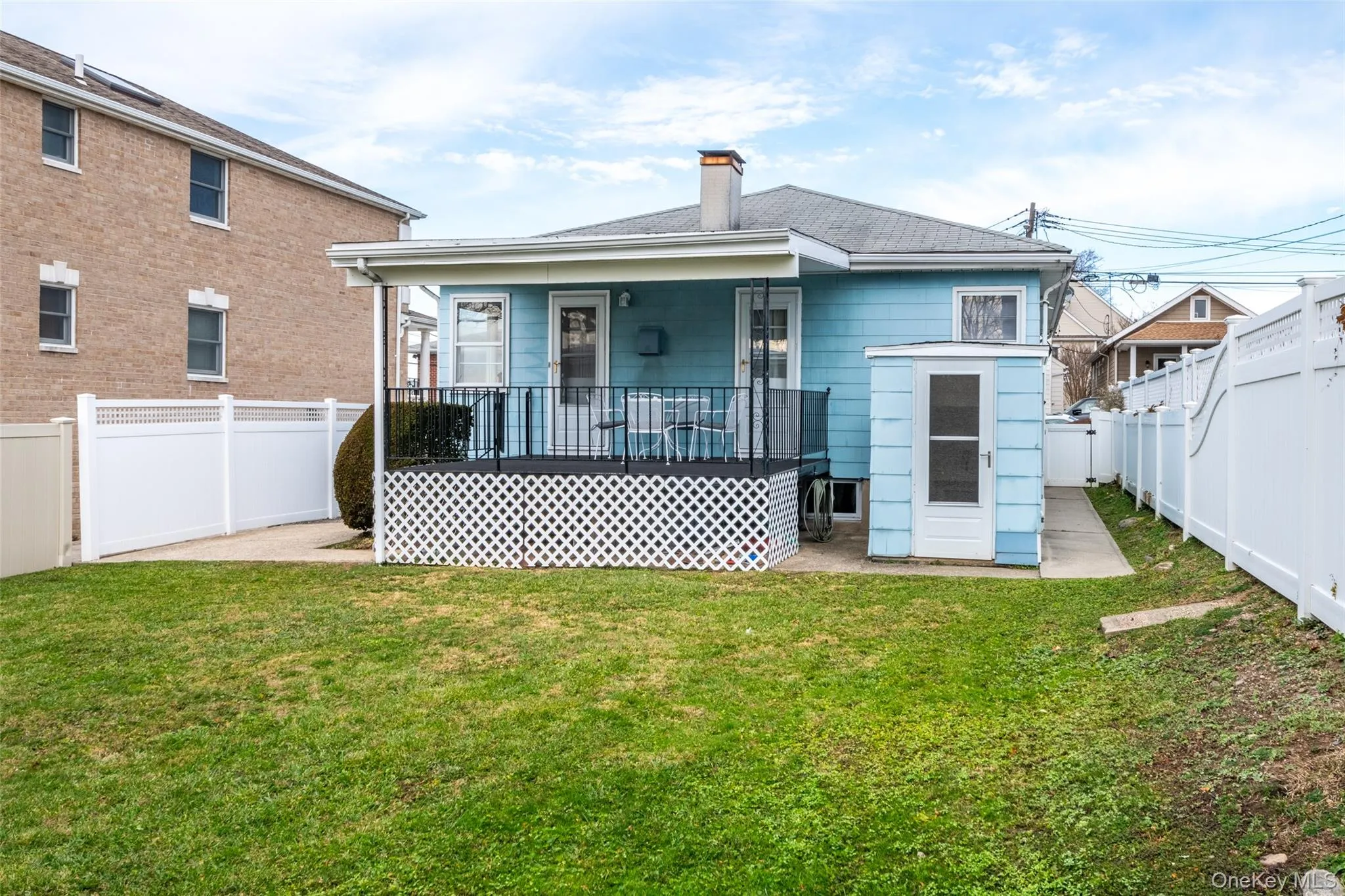 Rear view of house with a fenced backyard, a patio area, and a chimney Rear view of house with a fenced backyard, a patio area, and a chimney
