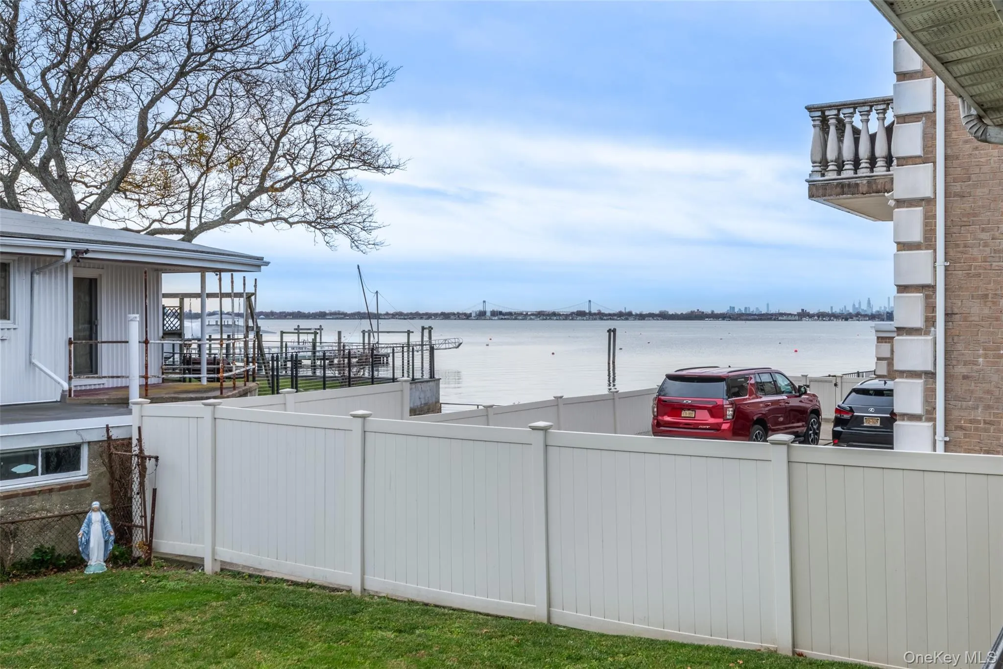 View of yard with a balcony and a water view View of yard with a balcony and a water view