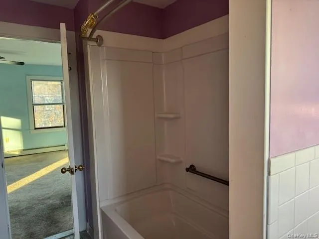 Full bath , a baseboard radiator, and shower / bathtub combination Full bath , a baseboard radiator, and shower / bathtub combination