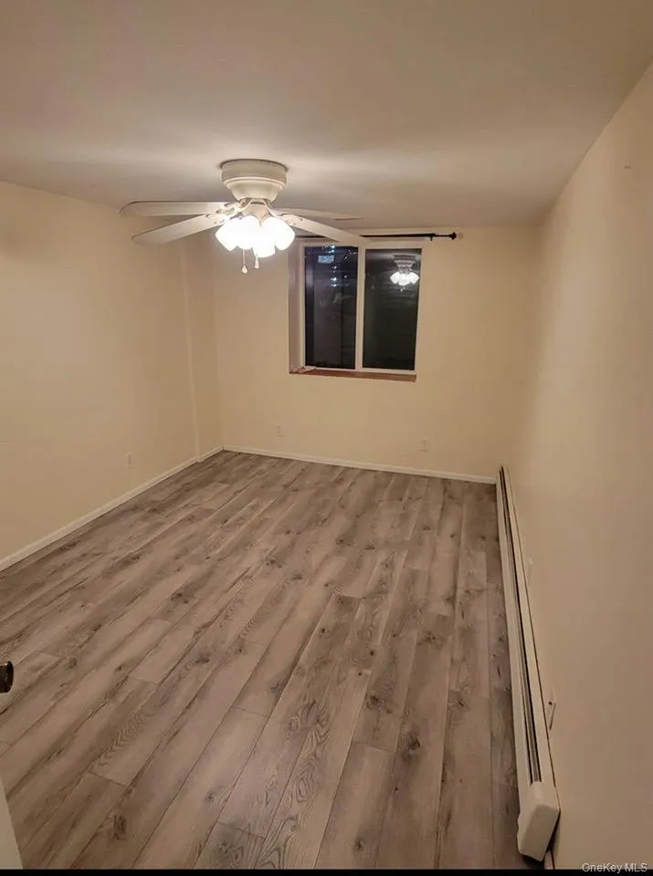 bedroom didn t angel featuring light wood-style floors, a baseboard radiator, and ceiling fan bedroom didn t angel featuring light wood-style floors, a baseboard radiator, and ceiling fan