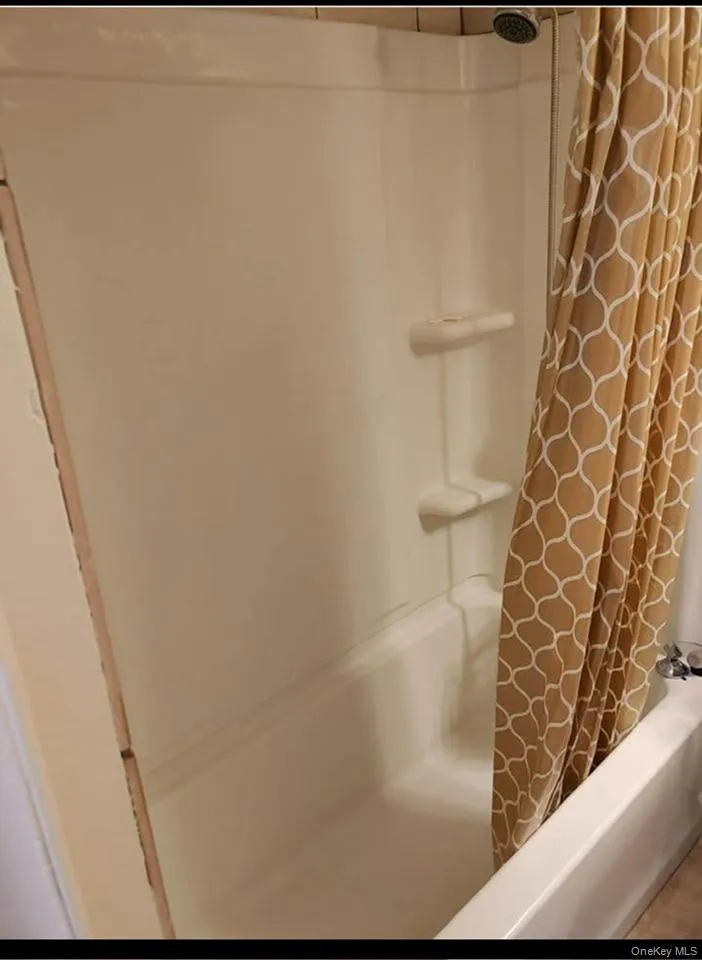 Bathroom with shower / tub combo with curtain Bathroom with shower / tub combo with curtain