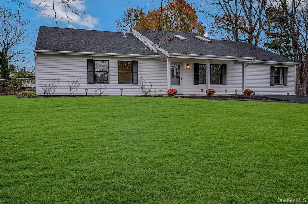 View of front of house featuring a front lawn, a shingled roof, and covered porch View of front of house featuring a front lawn, a shingled roof, and covered porch