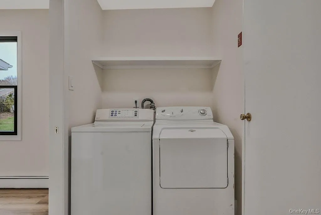 Laundry room with tiled finished floors, washer and dryer Laundry room with tiled finished floors, washer and dryer