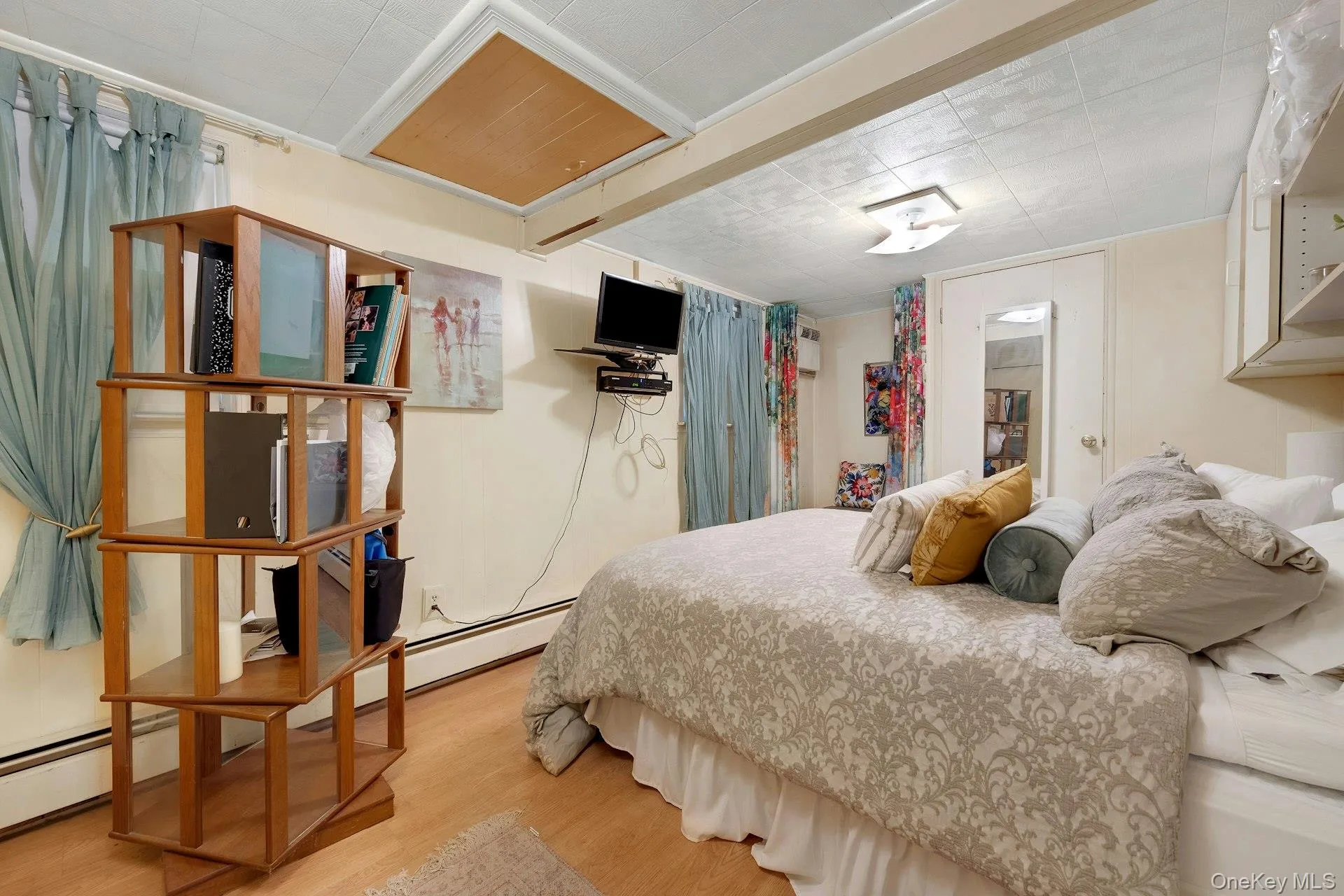 Primary bedroom - with storage area and bench plus access to attic Primary bedroom - with storage area and bench plus access to attic