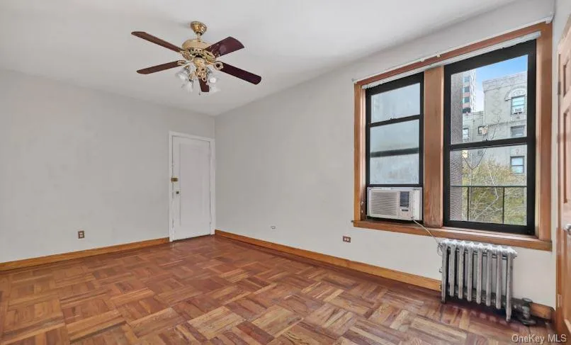 Spare room with radiator and ceiling fan Spare room with radiator and ceiling fan