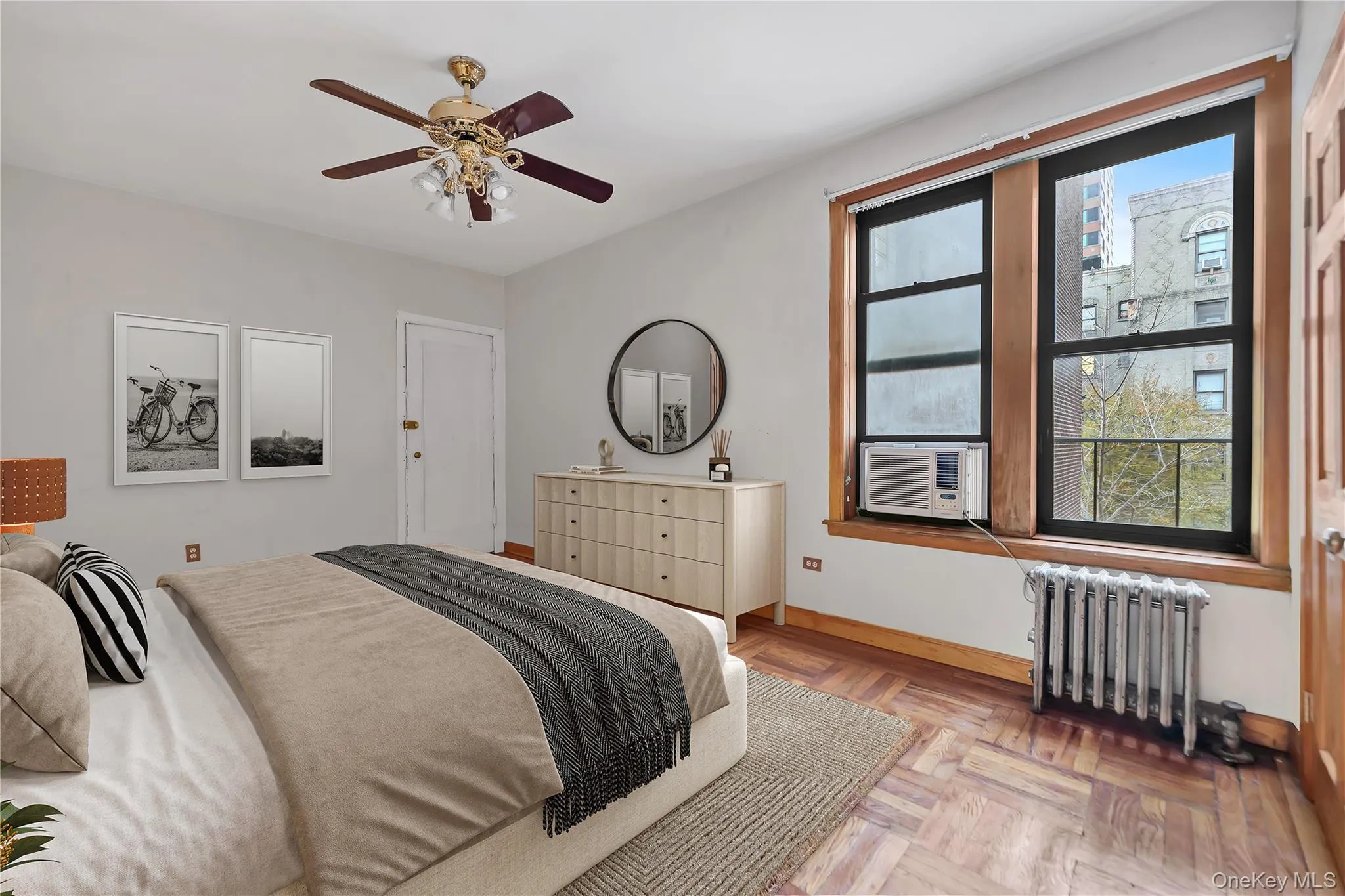 Bedroom featuring radiator heating unit and ceiling fan Bedroom featuring radiator heating unit and ceiling fan