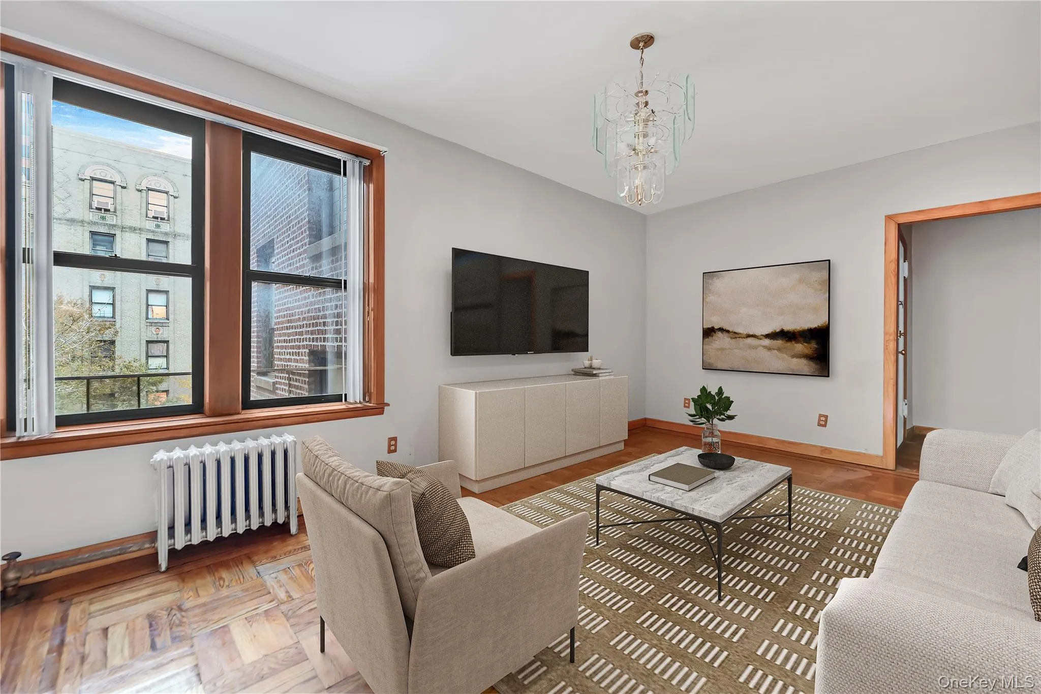 Living room with radiator heating unit and a chandelier Living room with radiator heating unit and a chandelier