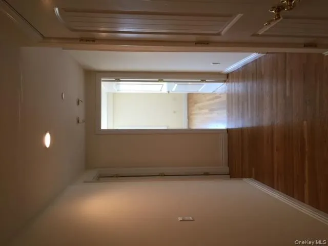 Hallway with wood finished floors and recessed lighting Hallway with wood finished floors and recessed lighting