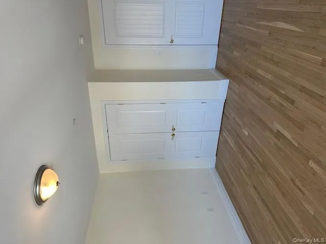 Unfurnished bedroom featuring wood finished floors and a closet Unfurnished bedroom featuring wood finished floors and a closet