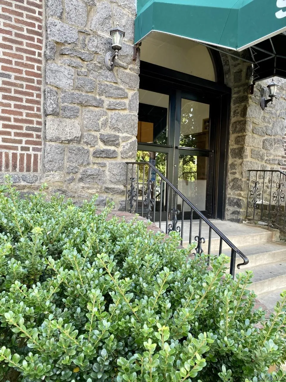 Entrance to property featuring stone siding Entrance to property featuring stone siding