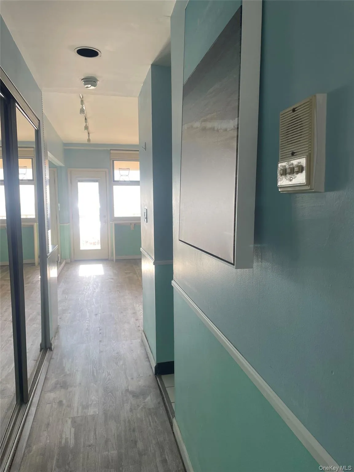 Hall featuring wood finished floors and baseboards Hall featuring wood finished floors and baseboards