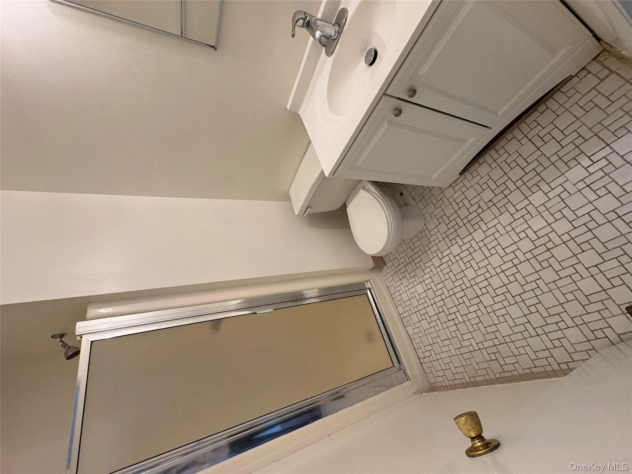 Full bath with a shower stall, vanity, and light tile patterned floors Full bath with a shower stall, vanity, and light tile patterned floors